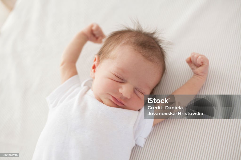 baby waking up cute baby lying in bed and waking up Baby - Human Age Stock Photo