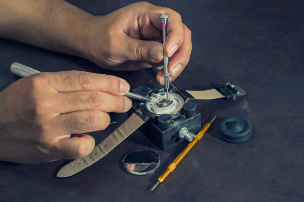 istock watchmaker try to repair watch on tools and table 648267922