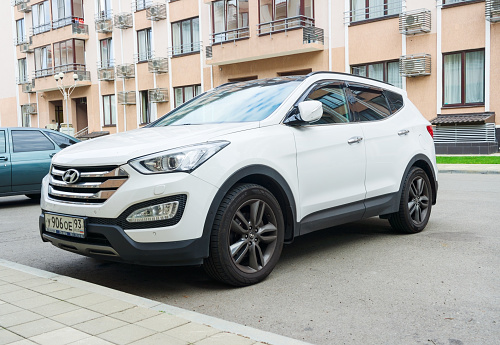 Sochi, Russia - October 11, 2016: New white Hyundai Santa Fe parked on the street near the house.