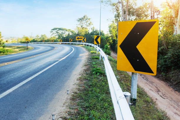 curve warning sign on the road - sharp curve imagens e fotografias de stock