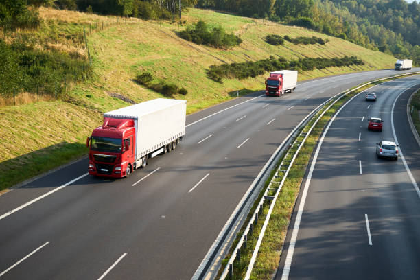 istock Three trucks and three cars driving on the highway 648272198