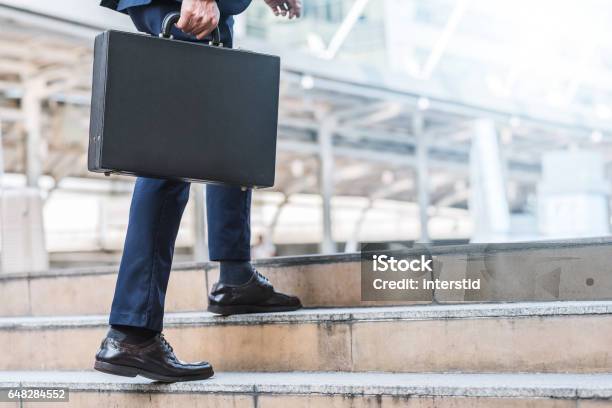 Businessman Holding Leather Briefcase While Walking Stock Photo - Download Image Now