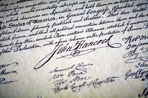 Close up the signature of John Hancock on Declaration of Independence with shallow depth of field