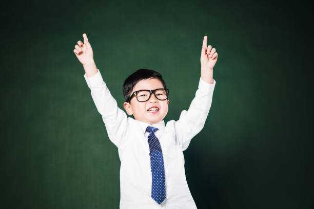 istock Happy little business man smiling with hands raised 648311894