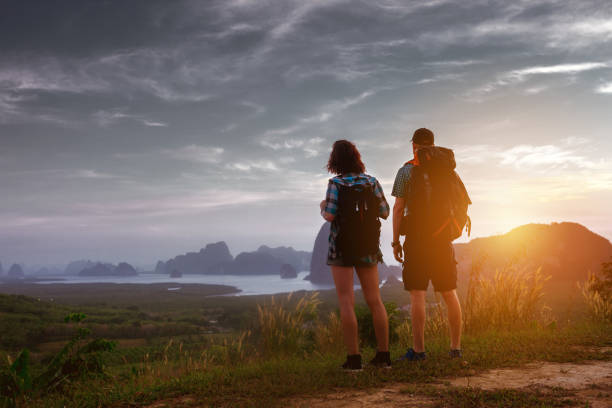 istock Couple sunrise sunset backpack tourism concept 648316590