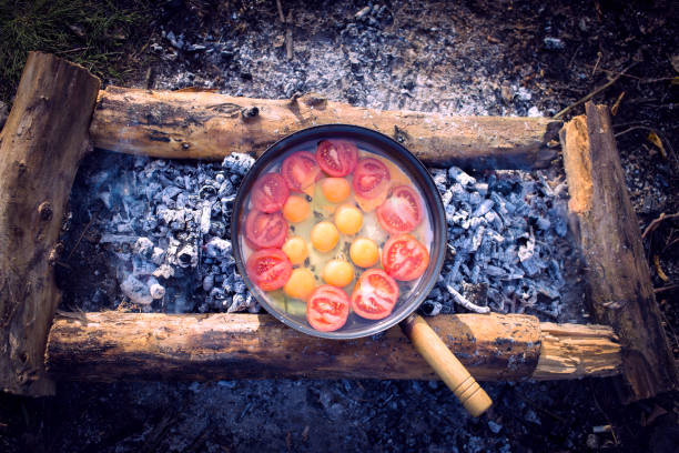 istock Cooking breakfast  over a campfire at a campsite. 648316610