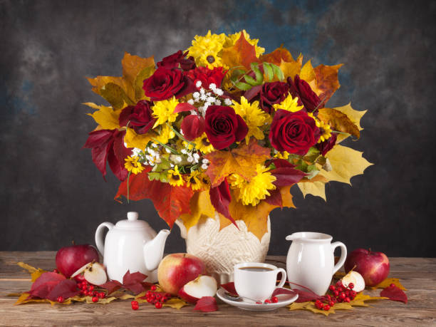 istock Autumn still life. Tea, flower and yellow leaves. 648323664