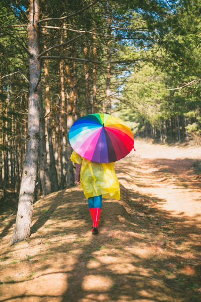 istock Young woman is walking in a forest 648326786