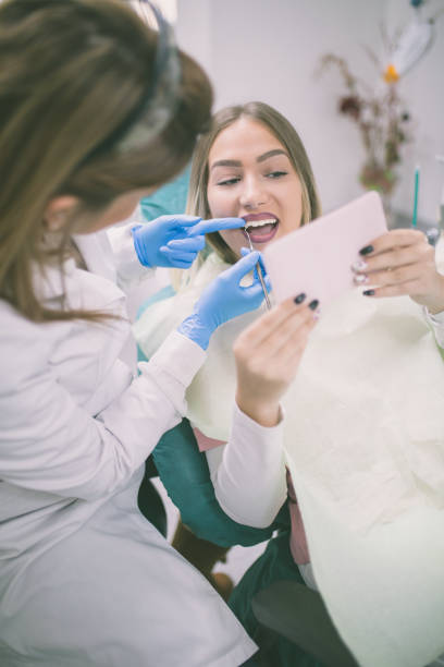 istock Dentist curing a female patient 648330110