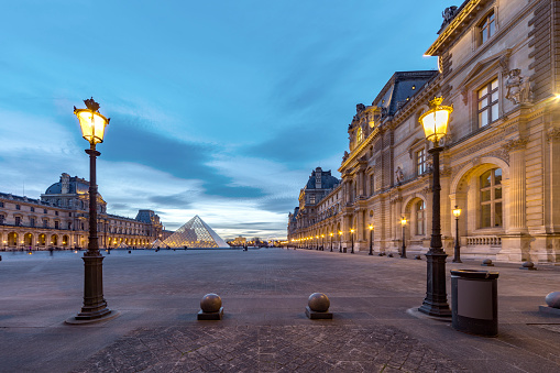 PARIS 25 February 2017 - Lampposts lit at the twilight, sunset moment at the louvre museum in Paris