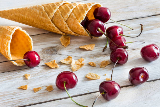 Waffle cones and cherry on the wood