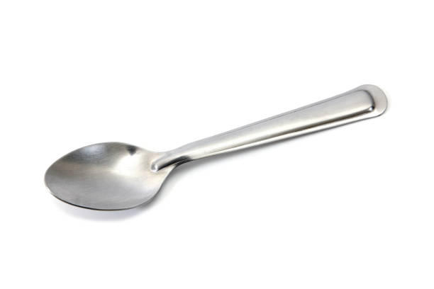 istock Stainless steel glossy metal kitchen spoon isolated over the white 648345406