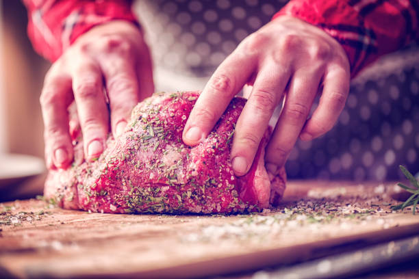 istock Rolling Fresh Roast Beef into Herbs and Spices 648348594