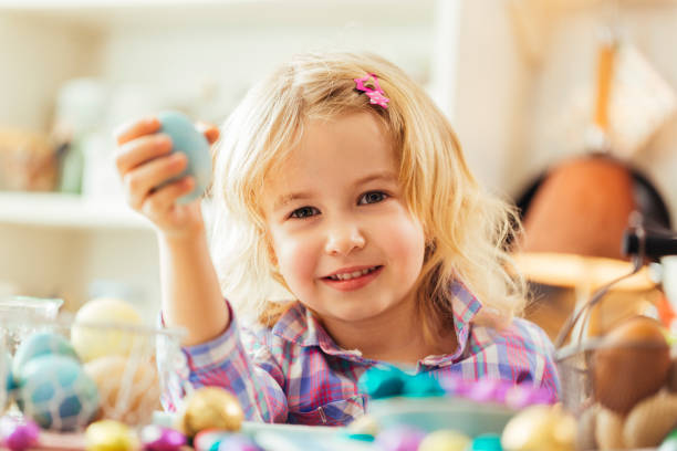 istock Little Girl Holding Natural Dyed Easter Egg 648348936