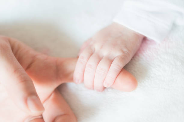 istock Baby hand detail 648351664