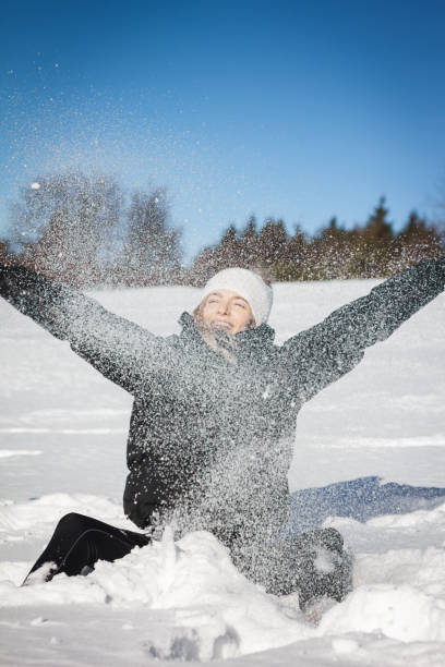 istock Beautiful woman playing with snow 648354794