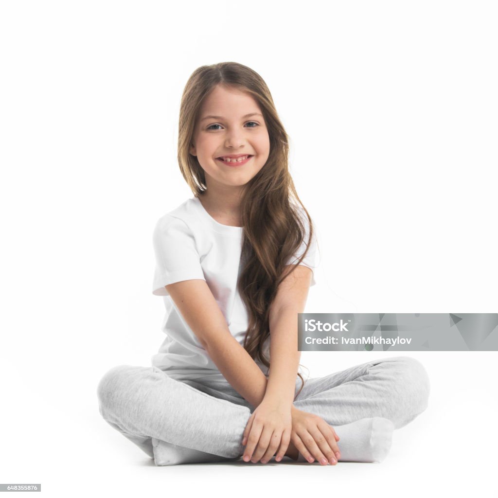 Girl sitting turkish Portrait of small girl sitting turkish isolated on white background Child Stock Photo