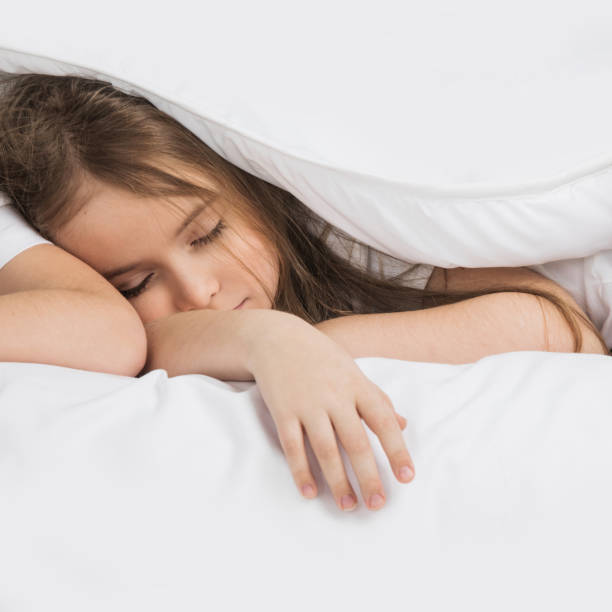 istock Girl sleeping in bed 648355920