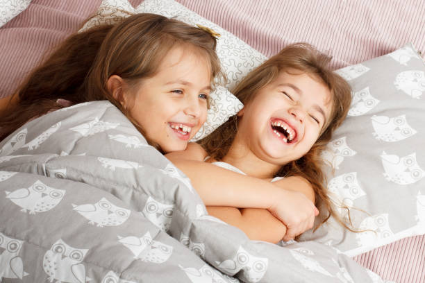 istock two girls who laugh, enjoy and play 648359212