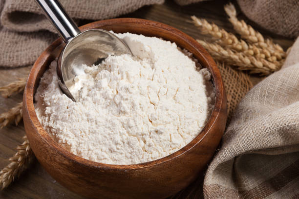 istock Scoop and flour in a bowl on the old board 648366622