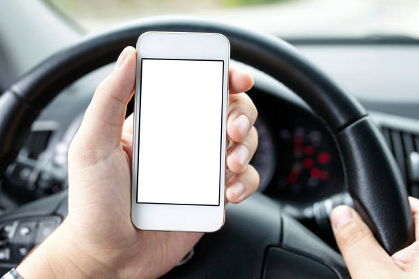 istock driver in the car holding phone with isolated screen 648374180