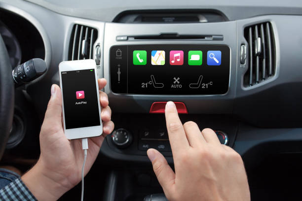 istock man connecting phone to the car media system 648377334