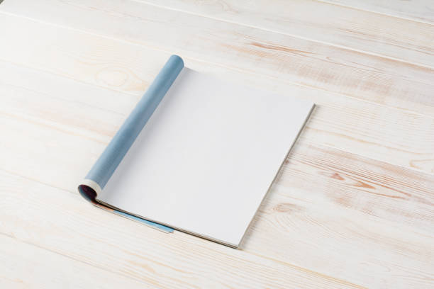 istock Mock-up magazines or catalog on wooden table background. 648380180