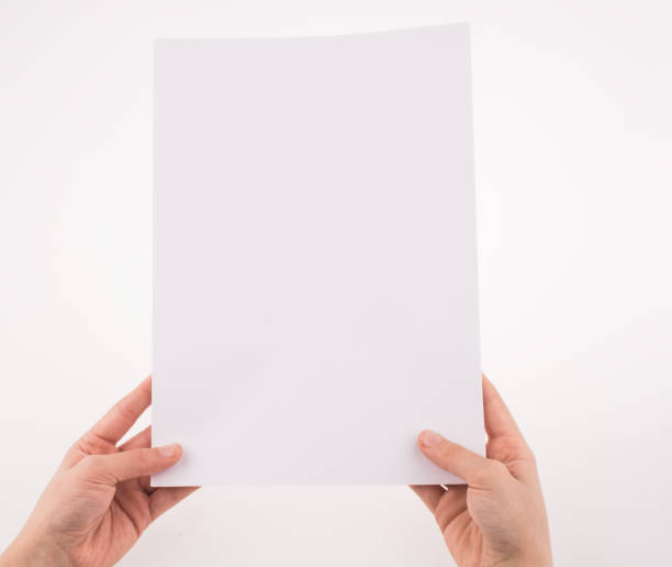 istock Hand holding a white blank sheet of paper 648381468