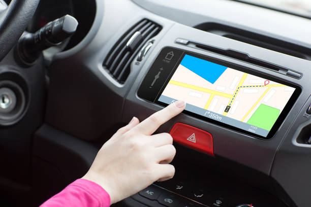 istock woman sitting in a car and touch play finger in a navigation map 648384588