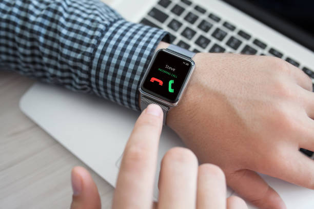 istock Man hand with watch and phone call on the screen 648387996