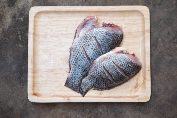 istock Fresh fish tilapia on wooden tray 648388128