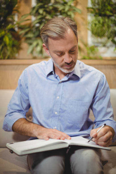 istock Attentive doctor writing in organizer 648390394