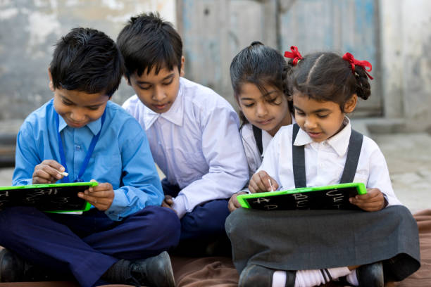 istock School children writing on slate 648397368