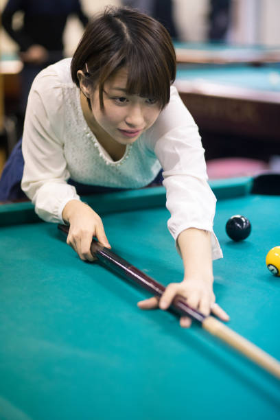 istock Young Japanese woman playing billiards 648397430