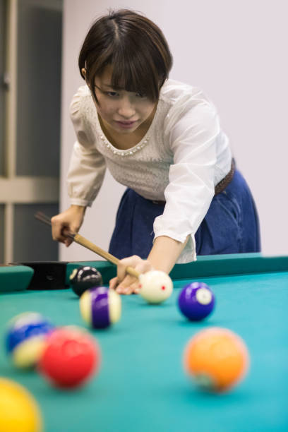 istock Young Japanese woman playing billiards 648397432