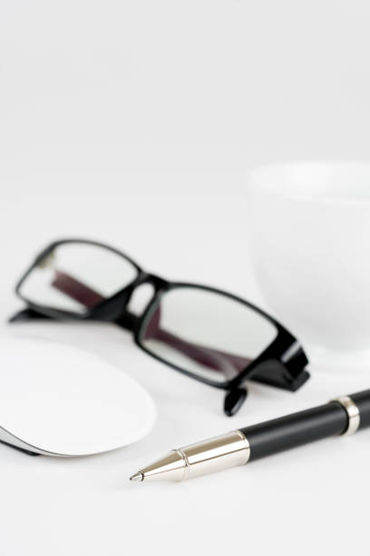 istock cup of coffee, pen, mouse and glasses, on a background 648401030