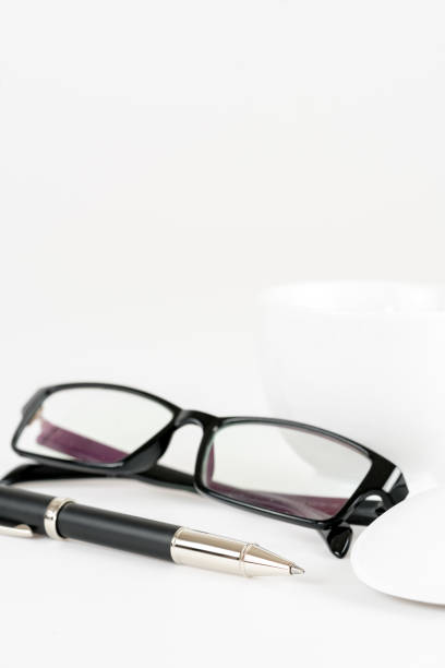 istock cup of coffee, pen, mouse and glasses, on a background 648407902