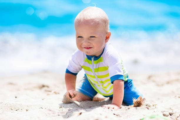 Baby boy on tropical beach stock photo
