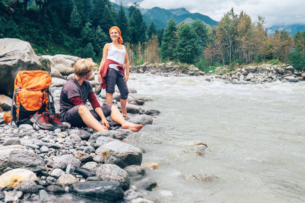 istock Two tourists refresh near the mountain river 648412016