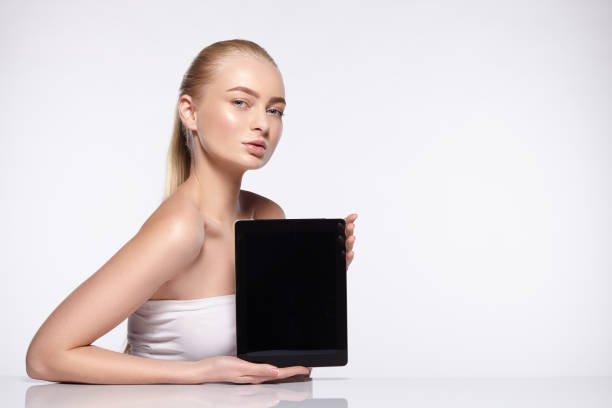 istock Blonde girl holds the tablet 648412032