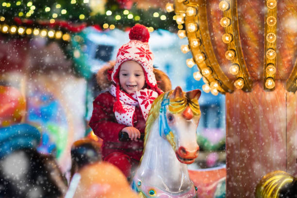 Child riding carousel on Christmas market