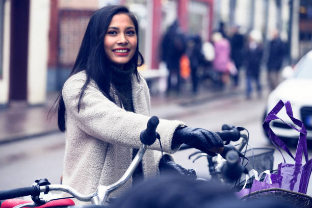 Smiling woman cycling in Helsingborg, Sweden