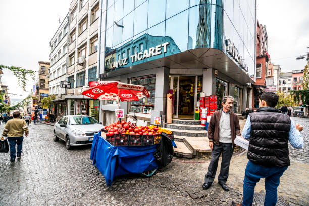 Istanbul, Turkey - October 27, 2014: Fruit vendor talking with man on the street.