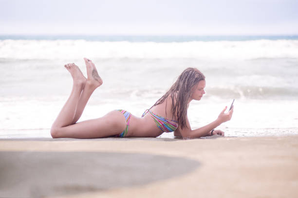 istock beautiful young woman on the beach 648416402