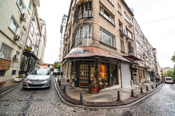 Istanbul, Turkey - October 27, 2014: Car moving on a narrow street. Few people walking