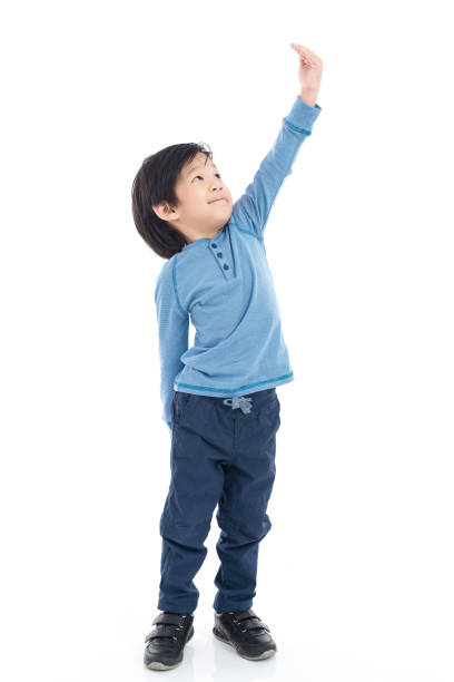 istock Asian Boy growing tall and measuring himself on white background isolated 648420602