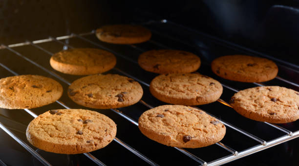 istock Chocolate chip cookies baking in home oven. 648427796