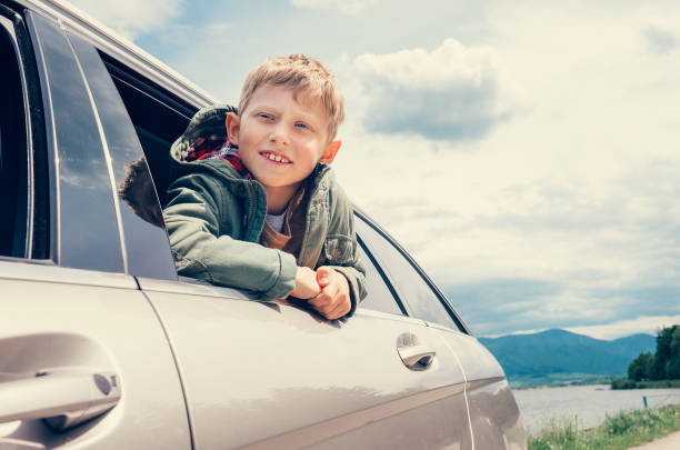istock Boy looks out from car window 648430284