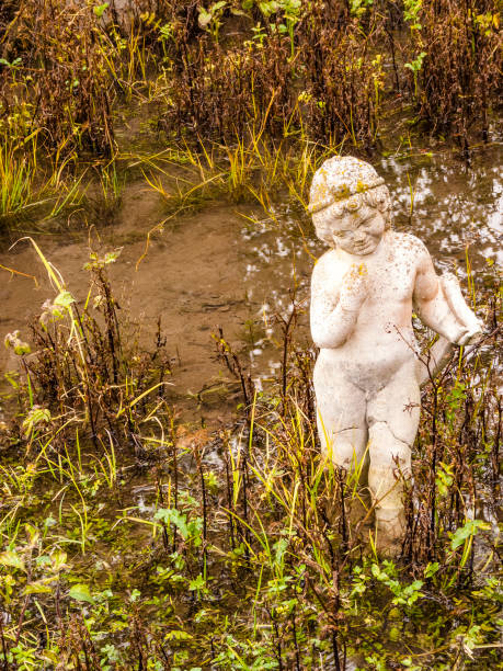 Vintage picture of Boy statue in a park.