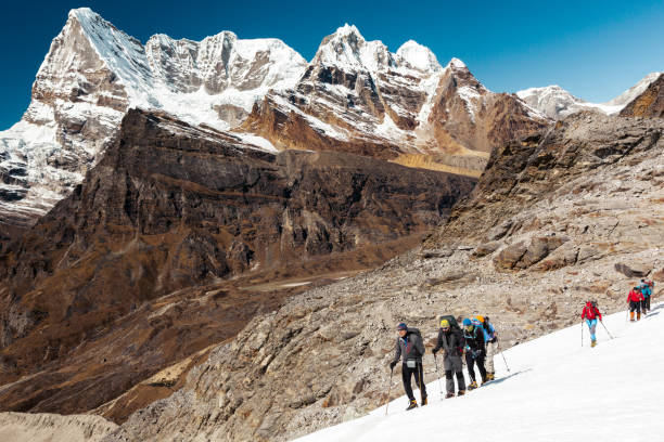 istock Alpine Climbers Team moving on Glacier high Mountains View Background 648435026
